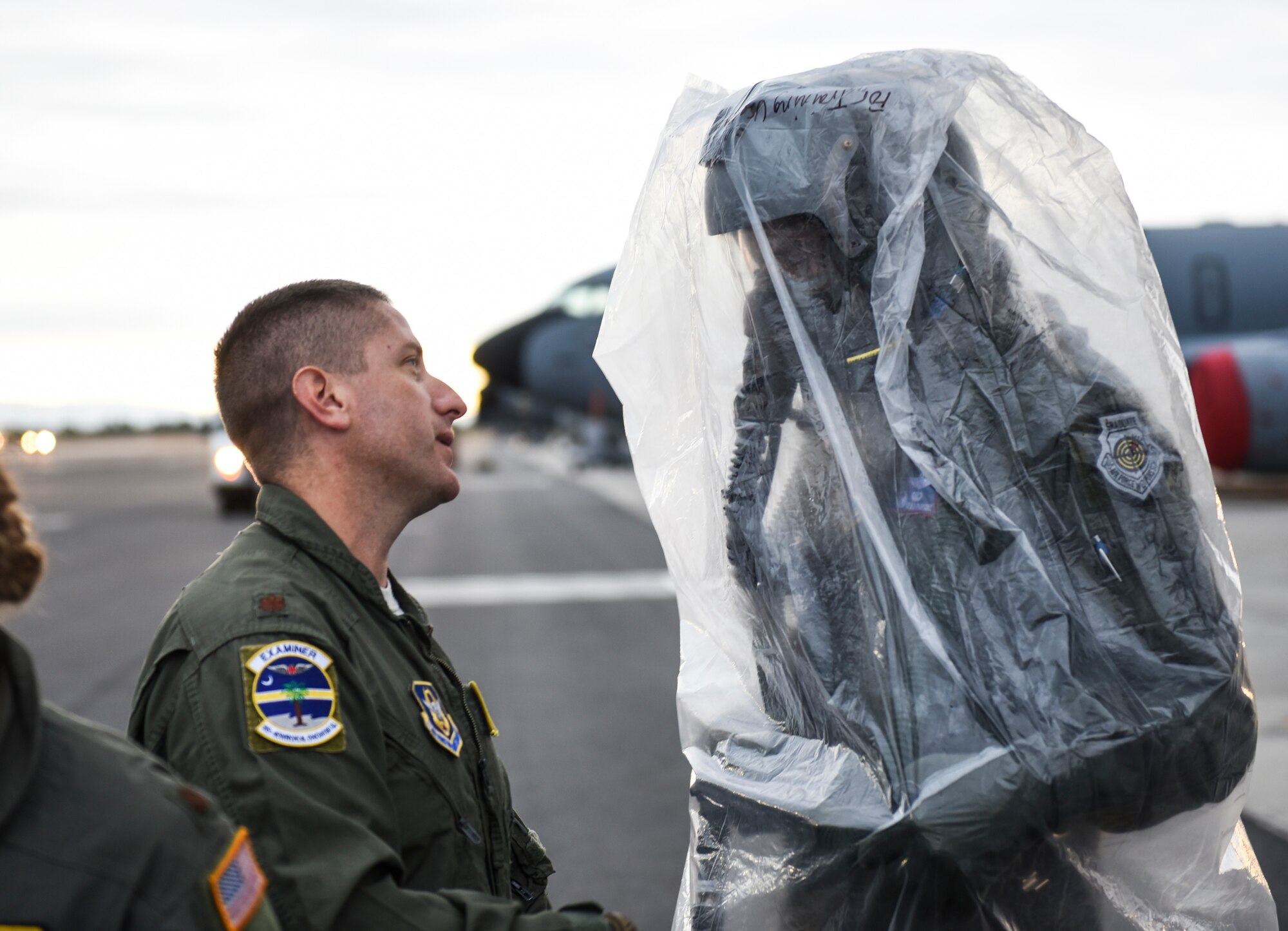 U.S. Air Force Lt. Col Kevin Parsons, right, 93rd Air Refueling Squadron commander assigned to Fairchild Air Force Base, Washington, discusses aeromedical evacuation mission details with Maj. Jeffrey Fox, 315th Aeromedical Evacuation Squadron flight nurse from Join Base Charleston, South Carolina, while wearing an Aircrew Eye and Respiratory Protection System (AERPS) Sept. 16, 2019, at Fairchild AFB during Exercise Mobility Guardian 2019.