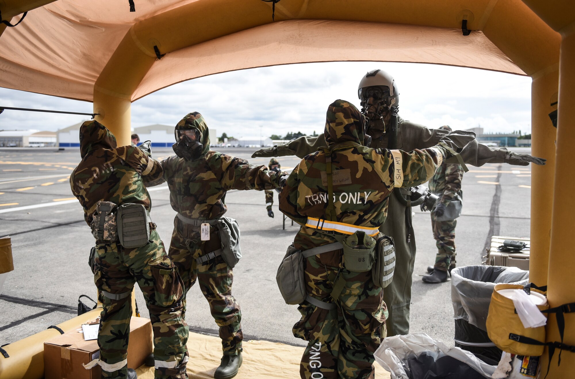 U.S. Air Force aircrew flight equipment Airmen perform decontamination procedures on KC-135 Stratotanker aircrew and passengers Sept. 16, 2019, at Yakima Air Terminal-McAllister Field, Washington, during Exercise Mobility Guardian 2019.