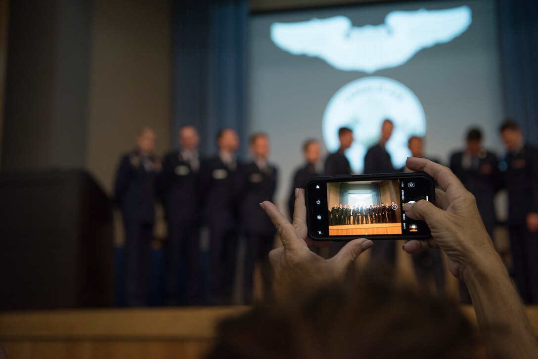 An attendee of Specialized Undergraduate Pilot Training class 19-25’s graduation ceremony takes a group picture at Laughlin Air Force Base, Texas, Spet. 27, 2019. Maj. Gen. Jeannie Leavitt, Air Force Recruiting Service commander, was the guest speaker at the ceremony, handing off wisdom to the newly pinned pilots. (U.S. Air Force photo by Staff Sgt. Benjamin N. Valmoja)