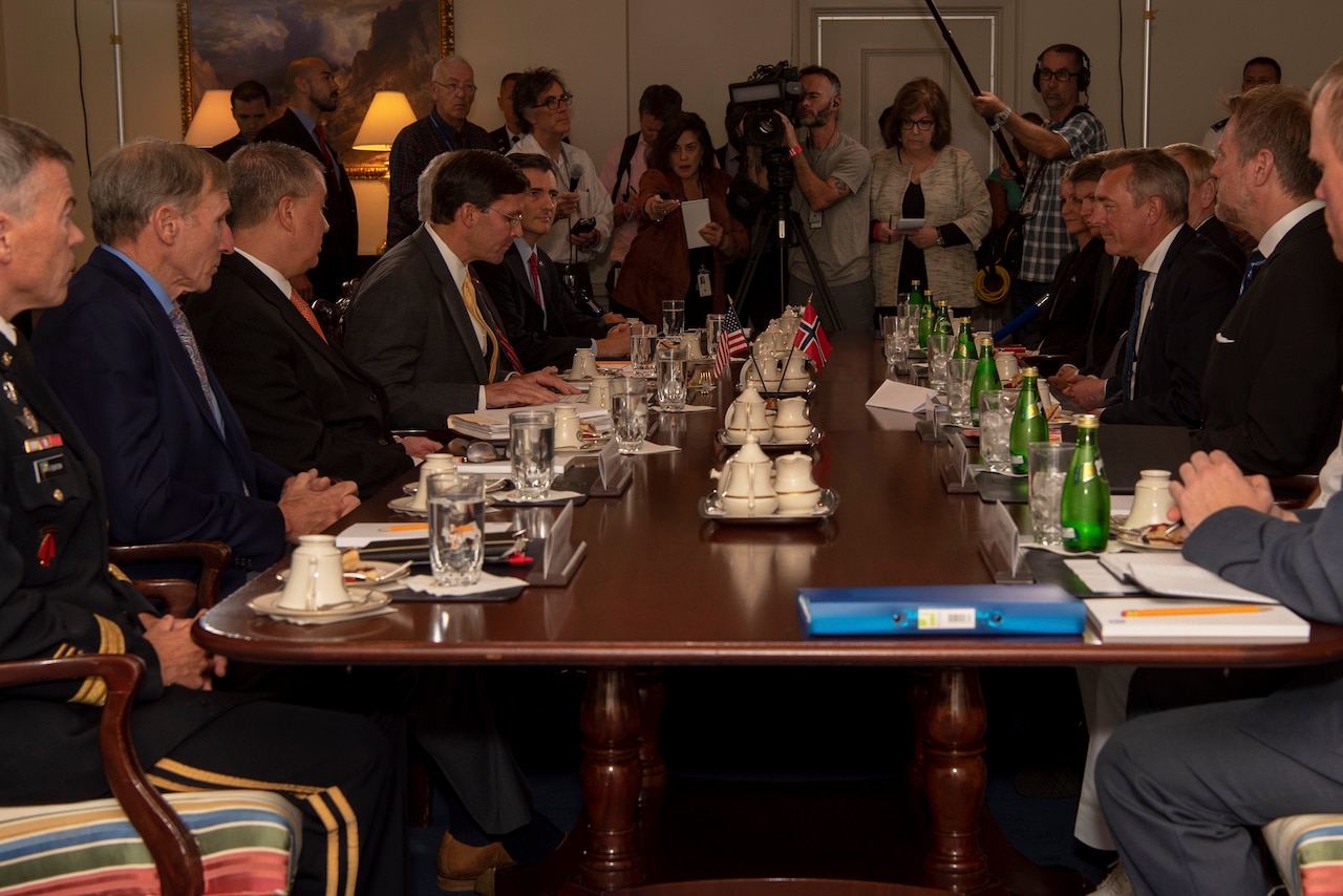 Defense Secretary Dr. Mark T. Esper sits across from his norwegian counterpart during a meeting.