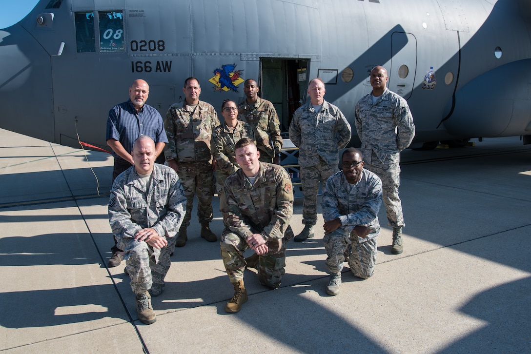 Members of the 166th Maintenance Operation Flight next to a C-130H2 aircraft on the flight line of the 166th Airlift Wing. The 166th MOF tracks and manages the maintenance of the wing's 8 C-130H2 tactical airlift aircraft, keeping them mission-ready. (U.S. Air National Guard Photo by Mr. Mitch Topal)