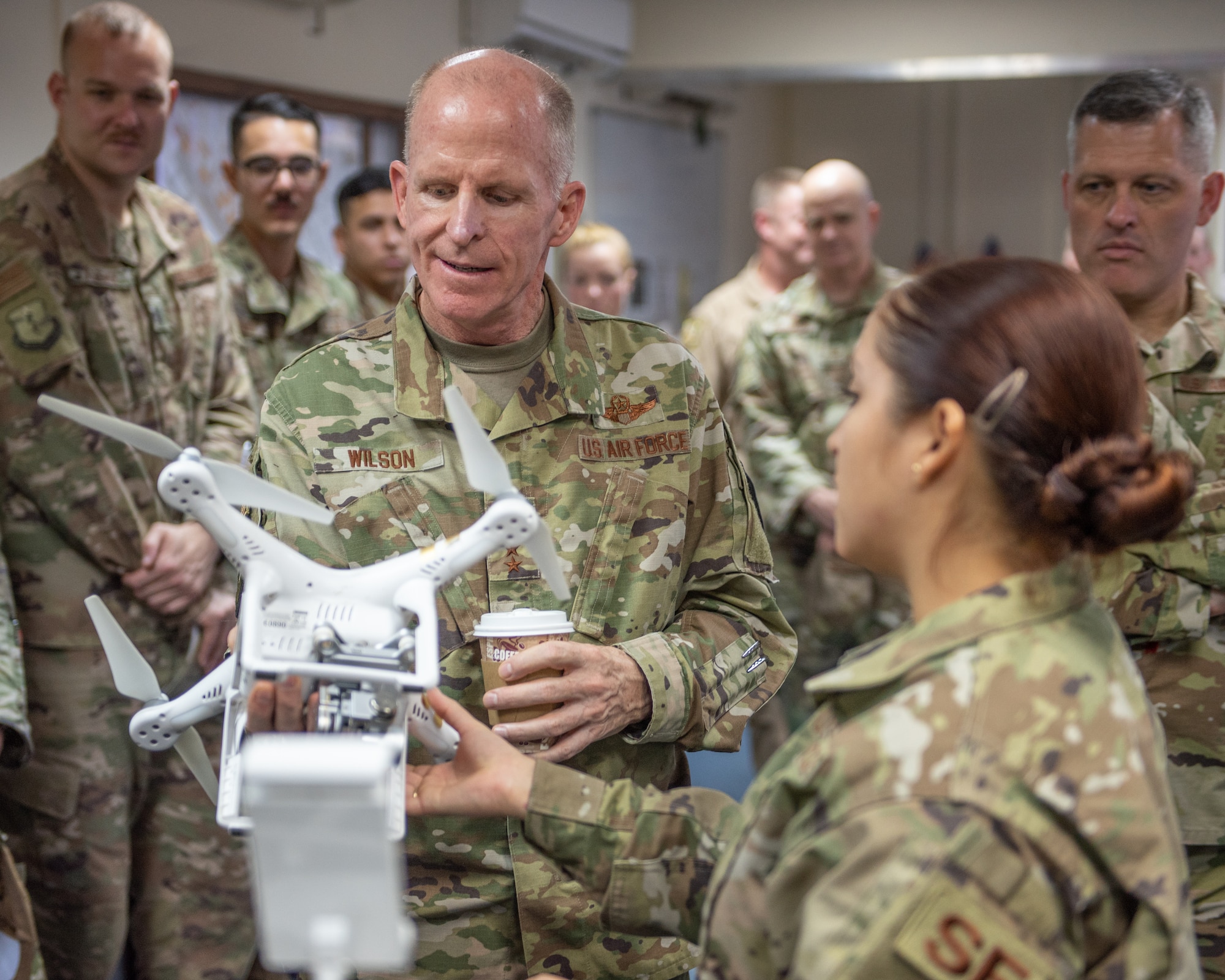 Air Force Vice Chief of Staff Gen. Stephen Wilson examines a small unmanned aerial system model with Capt. Brigitte Palacios, 380th Expeditionary Security Forces Squadron operations officer, in the base defense operations center Sept. 27, 2019 at Al Dhafra Air Base, United Arab Emirates. Palacios provided the general an overview of the ESFS role in the counter-sUAS program at ADAB. (U.S. Air Force photo by Staff Sgt. Chris Thornbury)