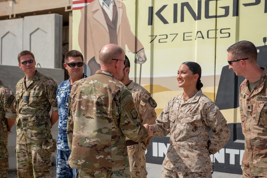 Air Force Vice Chief of Staff Gen. Stephen Wilson shakes the hand of U.S. Marine 1st. Lt. Lauren Kim, 727th Expeditionary Air Control Squadron, outside the Control Reporting Center Sept. 27, 2019 at Al Dhafra Air Base, United Arab Emirates. The CRC integrates U.S. Airmen, Marines, soldiers and allied partners to provide command and control support for the U.S. Central Command area of responsibility. (U.S. Air Force photo by Staff Sgt. Chris Thornbury)