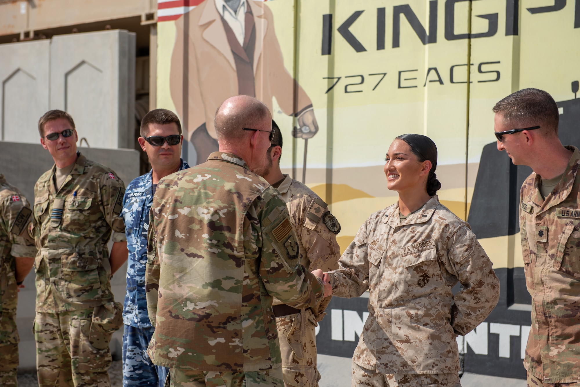 Air Force Vice Chief of Staff Gen. Stephen Wilson shakes the hand of U.S. Marine 1st. Lt. Lauren Kim, 727th Expeditionary Air Control Squadron, outside the Control Reporting Center Sept. 27, 2019 at Al Dhafra Air Base, United Arab Emirates. The CRC integrates U.S. Airmen, Marines, soldiers and allied partners to provide command and control support for the U.S. Central Command area of responsibility. (U.S. Air Force photo by Staff Sgt. Chris Thornbury)