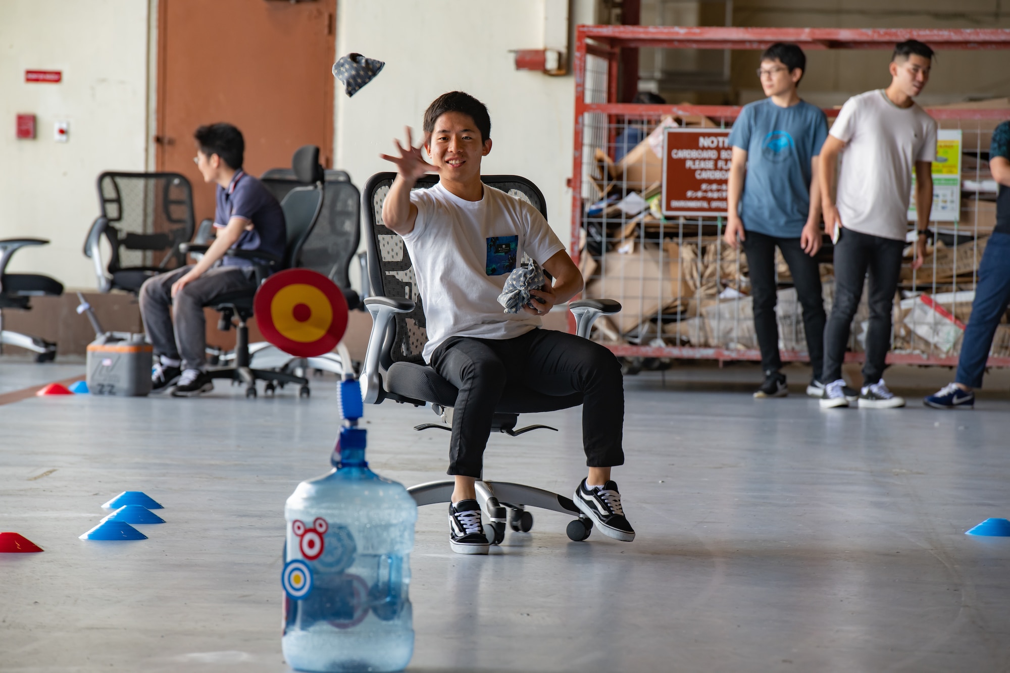 A university student throws a bean bag at a target during an interactive challenge for Air Force Immersion Day Sept. 23, 2019, at Kadena Air Base, Japan. The challenge taught students about the F-15 Eagle’s defensive and offensive counter air mission. (U.S. Air Force photo by Staff Sgt. Micaiah Anthony)