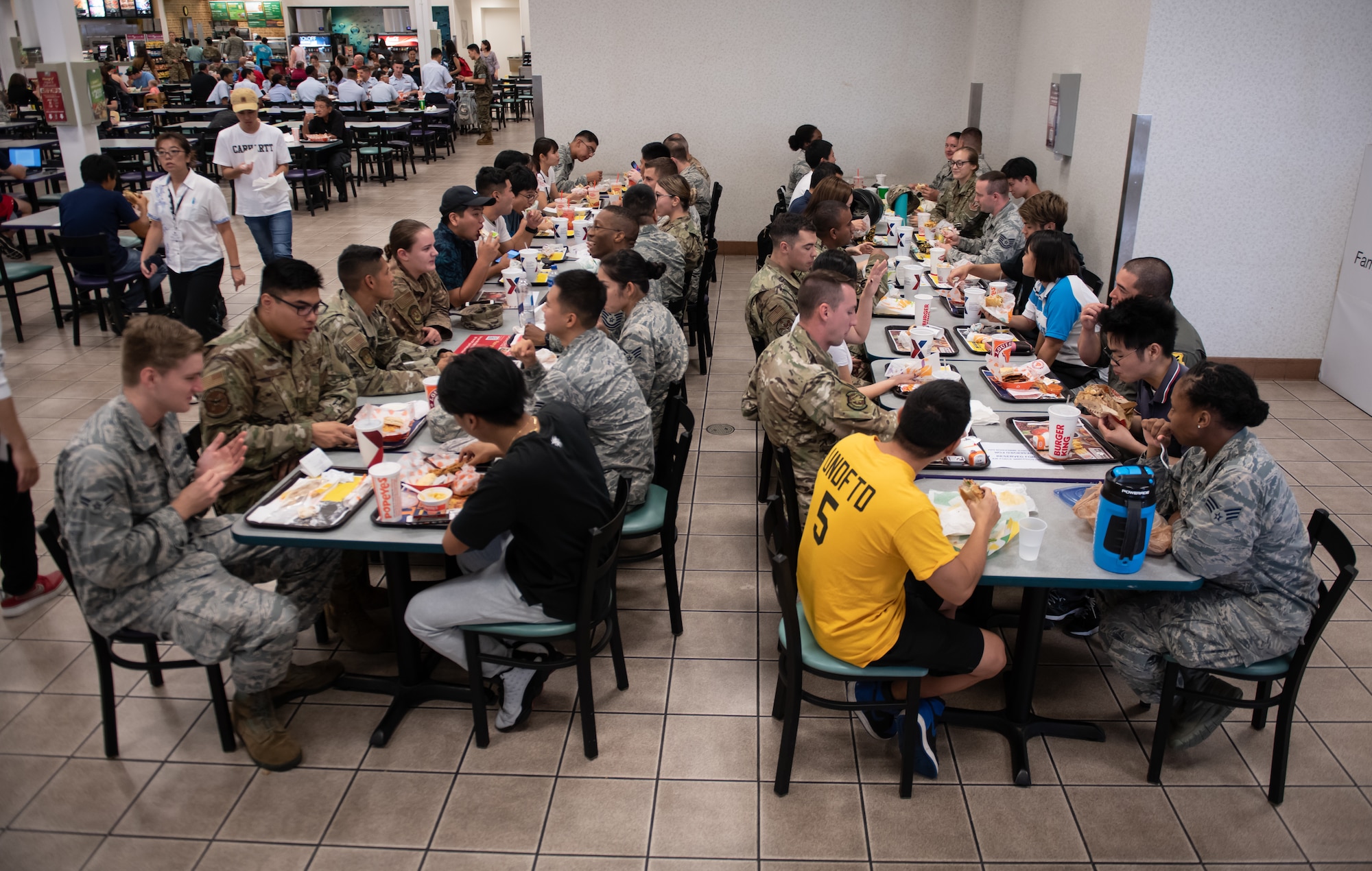 U.S. Air Force Airmen eat lunch with college students during Air Force Immersion Day Sept. 23, 2019, at Kadena Air Base, Japan. Air Force Immersion Day is a new community engagement program hosted by the base to teach college and vocational students about the 18th Wing’s mission. The luncheon enabled students to practice English and learn about Airmen’s jobs, families and experiences. (U.S. Air Force photo by Staff Sgt. Micaiah Anthony)