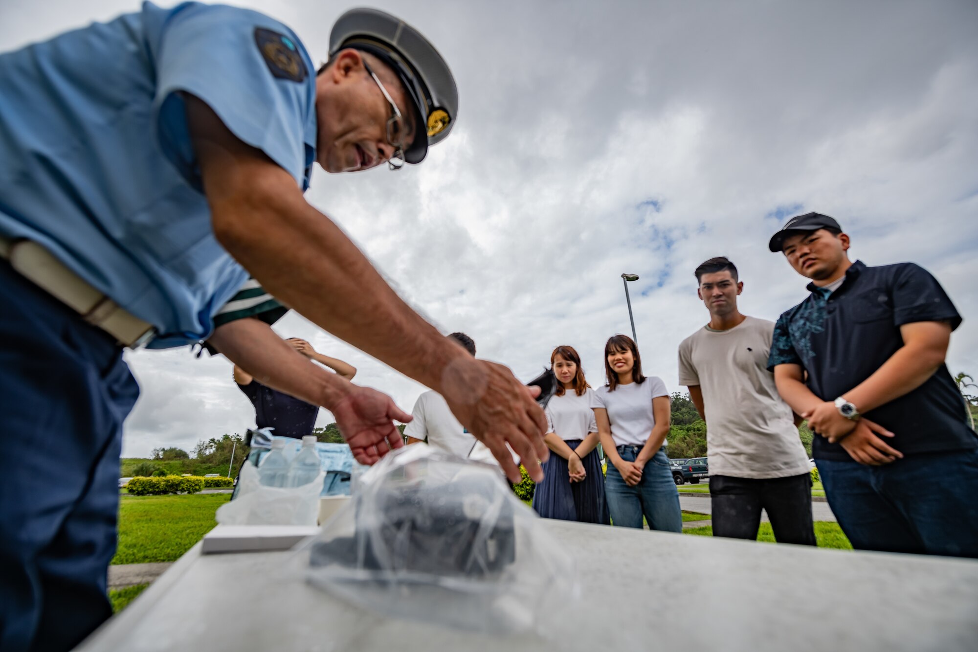 An Okinawa Prefectural Police officer shows students how they collect breathalyzer samples during Air Force Immersion Day, Sept. 23, 2019, at Kadena Air Base, Japan. The 18th Security Forces Squadron teamed up with the police to educate local students about their bilateral partnership and combined effort to combat and reduce intoxicated drivers on island. (U.S. Air Force photo by Staff Sgt. Micaiah Anthony)
