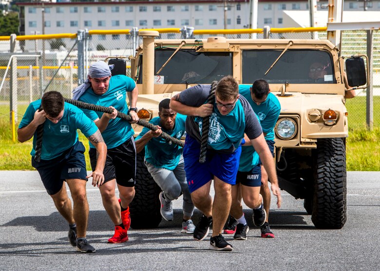 U.S. Marines with Combat Logistics Regiment 3, 3rd Marine Logistics Group, pull a humvee during the inaugural Ultimate Battle and Fear Factor Challenge at Camp Foster, Okinawa, Japan, Sept. 27, 2019.