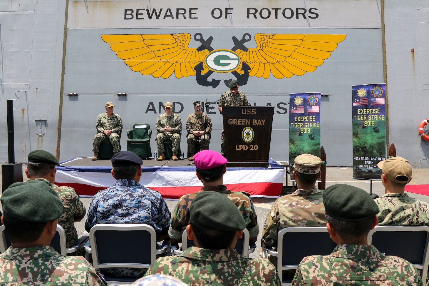 CELEBES SEA (Sept. 30, 2019) U.S. Marines with 3rd Marine Division, Sailors with the amphibious transport dock ship USS Green Bay (LPD 20) and service members with the Malaysian Armed Forces (MAF) hold an opening ceremony for exercise Tiger Strike 2019. Tiger Strike focuses on strengthening combined U.S. and Malaysian military interoperability and increasing combat readiness through amphibious operations and cultural exchanges between the MAF and the U.S. Navy, Marine Corps team.