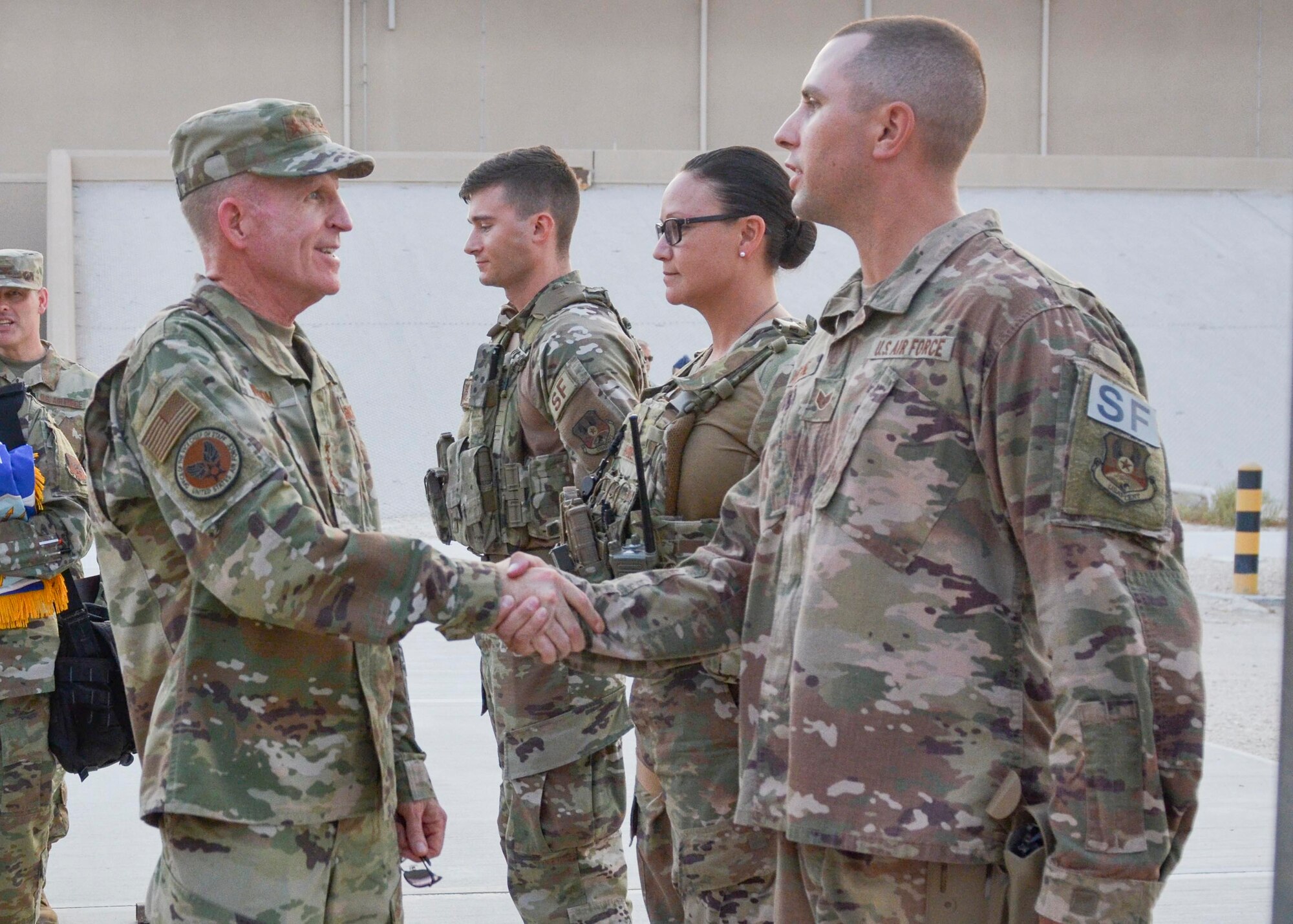 Gen. Wilson shakes hands with Security Forces members.