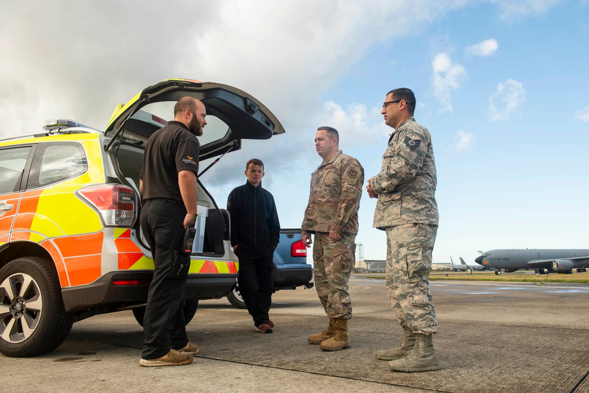 Airmen from the 100th Air Refueling Wing safety office talk to personnel from the Bird/Wildlife Aircraft Strike Hazard team at RAF Mildenhall, England, Sept. 26, 2019.  Airmen from the 100th ARW Safety office play a vital role in keeping Airmen safe by enforcing rules and regulations for safe working environments, providing safety briefings and inspecting each unit’s work stations. (U.S. Air Force photo by Senior Airman Luke Milano)