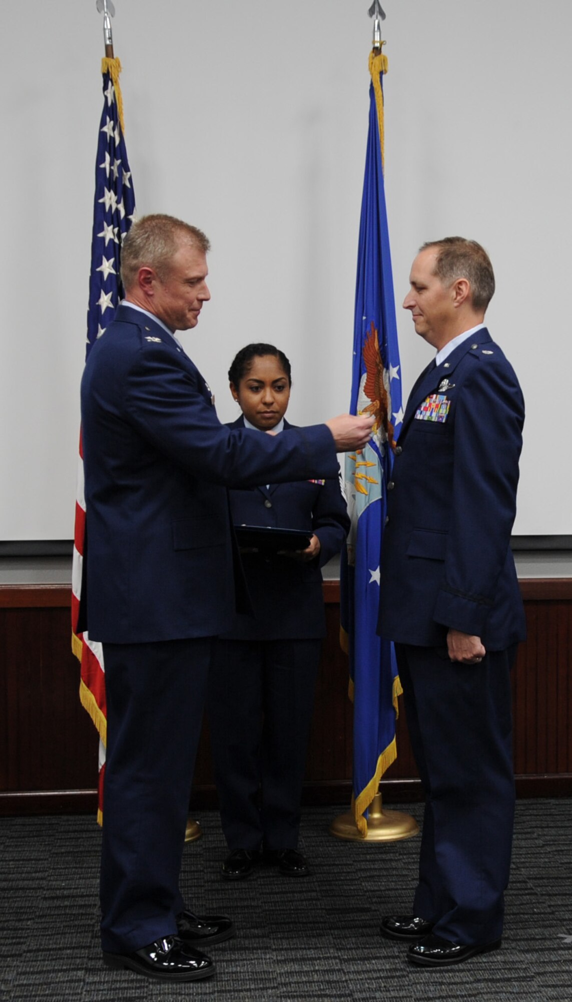 340th Flying Training Group Commander Col. Allen Duckworth presents the Meritorious Service Medal to Lt. Col. Timothy Chapman, former 340th FTG Reserve Undergraduate Flying Training Program manager, during Chapman's Aug. 29 retirement ceremony at Joint Base San Antonio-Randolph, Texas. Proffering for the ceremony is Master Sgt. Natasha Todd, group personnel specialist. (U.S. Air Force photo by Debbie Gildea)