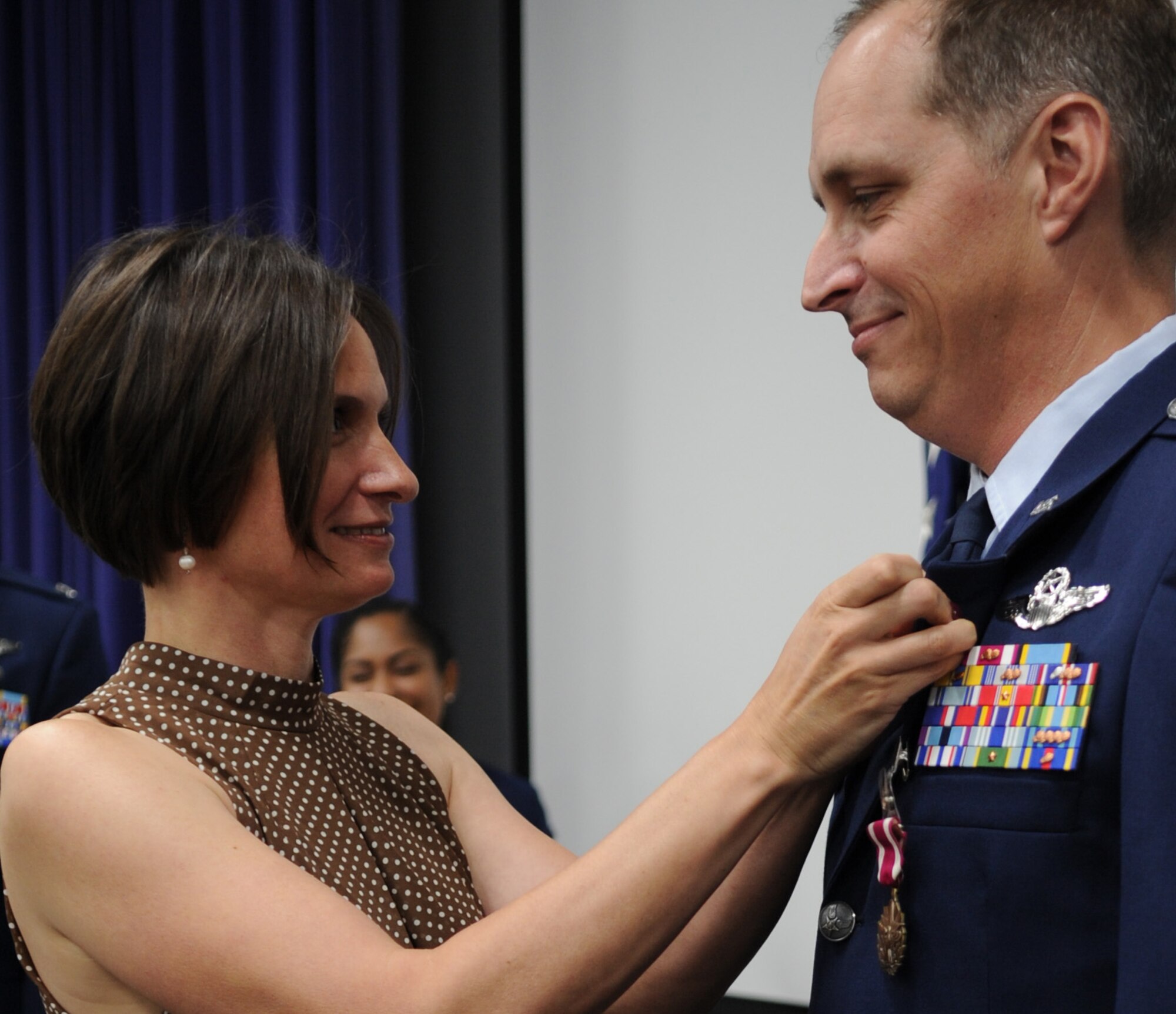 Christa Chapman pins the retirement pin to Lt. Col.  Timothy Chapman's lapel during the former 340th FTG Reserve Undergraduate Flying Training Program manager's Aug. 29 retirement ceremony at Joint Base San Antonio-Randolph, Texas. (U.S. Air Force photo by Debbie Gildea)