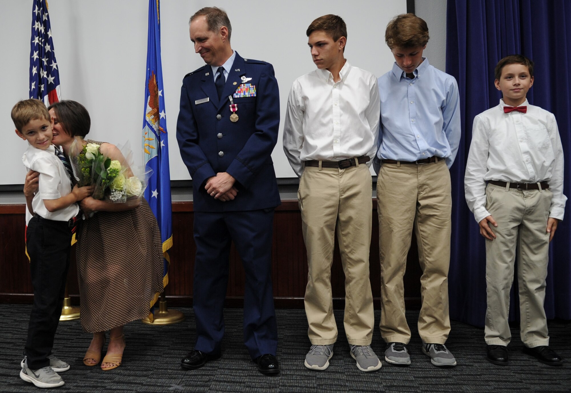 Christa Chapman accepts white roses from her four sons during retirement ceremonies held for husband Lt. Col.  Timothy Chapman during the former 340th FTG Reserve Undergraduate Flying Training Program manager's Aug. 29 retirement ceremony at Joint Base San Antonio-Randolph, Texas. Christa was honored by Chapman, their sons and the assembled guests for her role in Chapman's successful military career. (U.S. Air Force photo by Debbie Gildea)