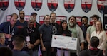 (Sept. 8, 2019) A team called “Cactus Balloon Scream” who received 1st place for track 1, receive a check for $20,000 for their participation during the HacktheMachine competition at the Brooklyn Navy Yard in New York City, Sept. 8, 2019. HACKtheMACHINE is where people from diverse backgrounds and professions work alongside military and government personnel to help the U.S. Navy solve its foremost cyber and technical problems. (U.S. Navy photo by Mass Communication Specialist 1st Class Bryan Ilyankoff/Released)