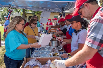 Volunteers serve guests at the Brooke Army Medical Center Fisher House’s 26th Annual Founder’s Day Celebration at Joint Base San Antonio-Fort Sam Houston Sept. 20. The Young Farmers of Gonzales, Texas, served more than 1,400 pounds of brisket and more than 800 pounds of sausage; and organizations from around San Antonio were on hand to help serve the meals.