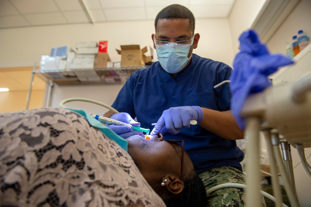 A dentist treats a patient