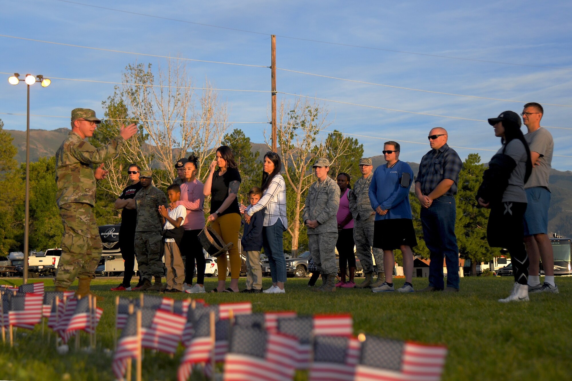 Airmen gather for a Suicide Prevention Month candlelight vigil Sept. 26, 2019, at Hill Air Force Base, Utah. Throughout the day and during the vigil, Airmen placed flags in remembrance of a family member, friend or coworker who died by suicide. (U.S. Air Force Photo by Todd Cromar)