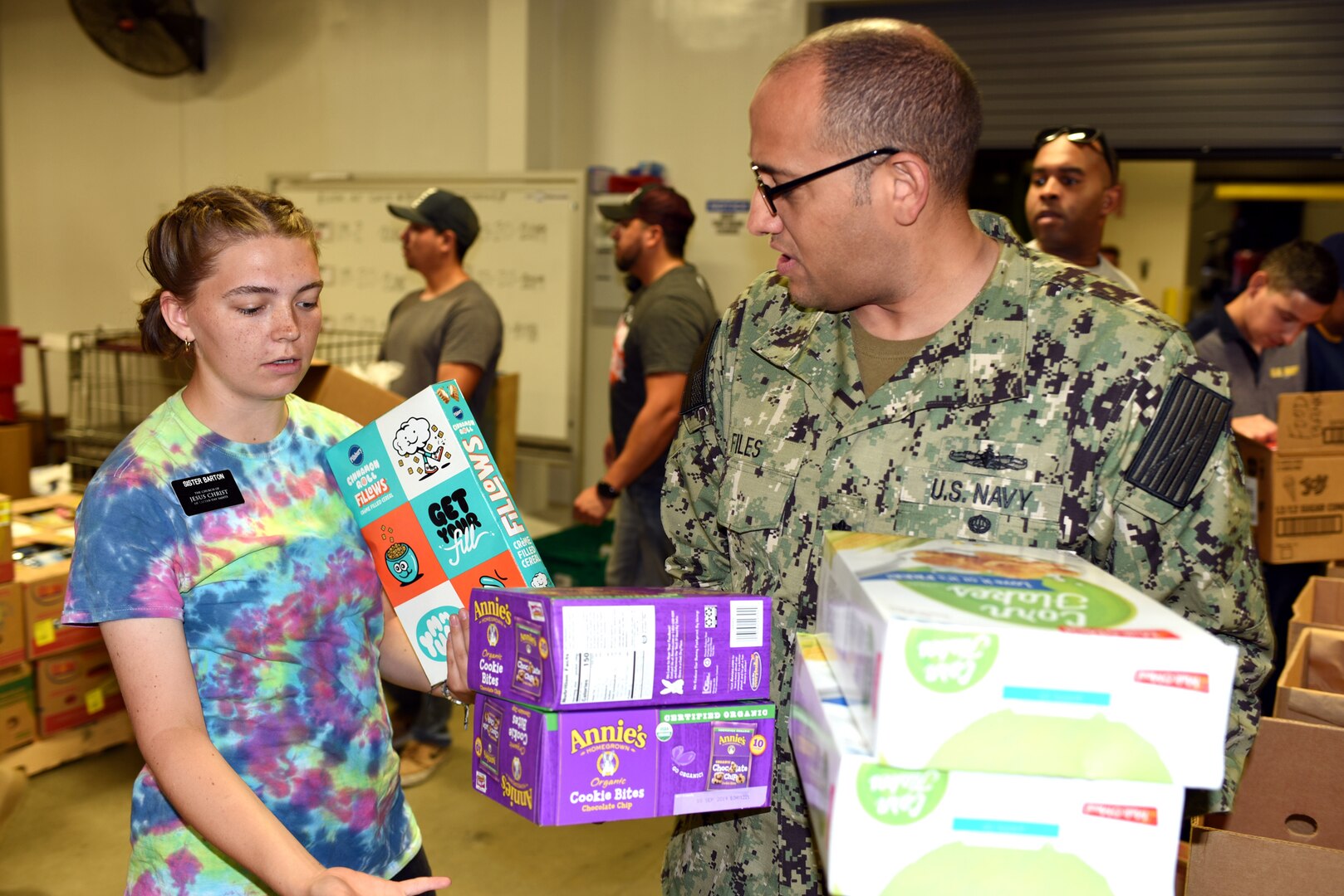 Cmdr. Michael Files (right), of Navy Recruiting District San Antonio executive officer, volunteers at the San Antonio Food Bank Sept. 27. Sailors assigned to NRD-SA journeyed to the food bank to provide community service through the Navy’s Community Relations Program.