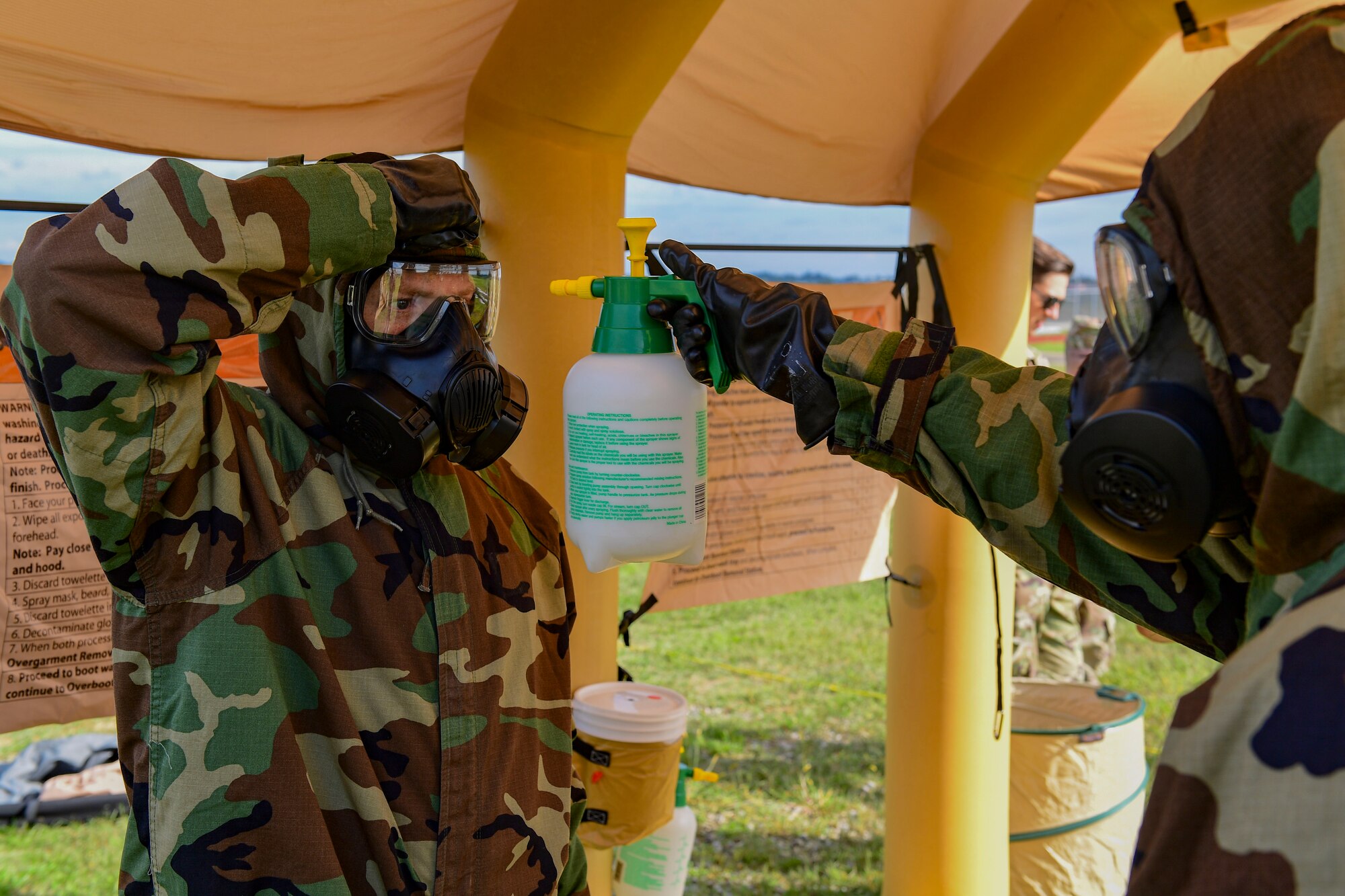 Master Sgt. Thomas Mimidis, emergency management supervisor with the 911th Civil Engineer Squadron, sprays off mission oriented protective posture gear on Tech. Sgt. Brian Vermeesch, foreman with the 911th Civil Engineer Squadron, during a joint decontamination exercise in Coraopolis, Pennsylvania, September 8, 2019.