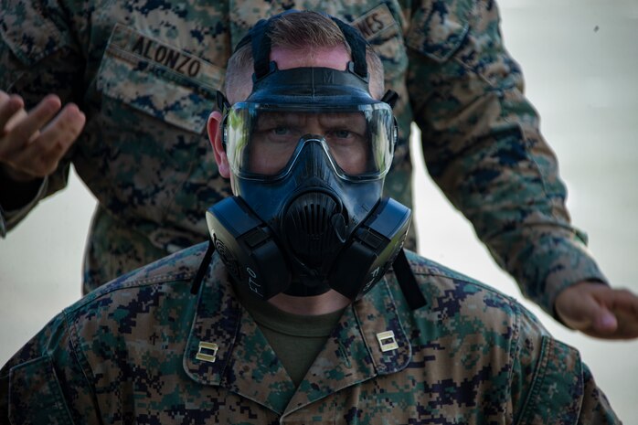 Cpl. Brandon Alonzo, a chemical, biological, radiological and nuclear defense specialist chief with Combat Logistics Battalion 31, 31st Marine Expeditionary Unit, instructs Marines on how to correctly don the M50 gas mask during a class on chemical safety and awareness at Camp Hansen, Okinawa, Japan, September 24, 2019. The 31st MEU, the Marine Corps' only continuously forward-deployed MEU, provides a flexible and lethal force ready to perform a wide range of military operations as the premier crisis response force in the Indo-Pacific region.