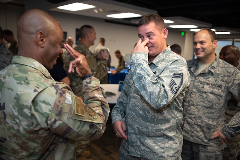 Senior Master Sgt. Cory Shipp, left, 50th Force Support Squadron superintendent, and Chief Master Sgt. Michael Dyer, center, 50th Network Operations Group chief enlisted manager, exchange hand gestures while trying to communicate a message without speaking during the chaplain-led communication game as Capt. Ronald Lawrence, right, 50th Space Wing chaplain, observes during the annual leadership appreciation breakfast at the event center, Schriever Air Force Base, Colorado, Sept. 26, 2019. Capt. Willy Gedeon, 50th Space Wing chaplain, organized the event as a way to recognize Schriever leaders for what they do every day and allow them an outlet to meet, connect and build resilience. (U.S. Air Force photo by Katie Calvert)