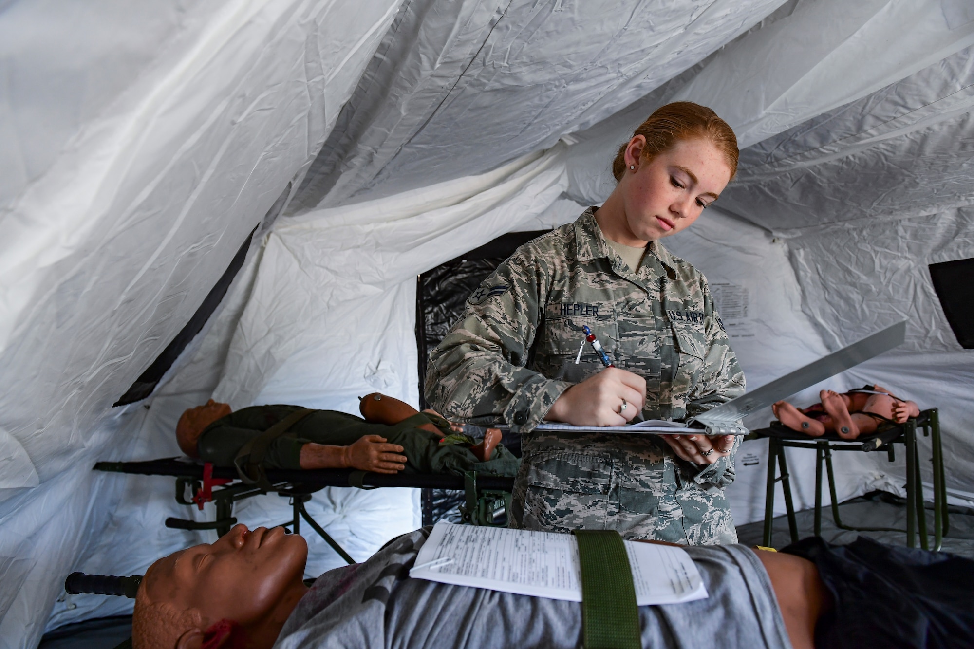 Airman 1st Class Jolene Hepler, 911th Aeromedical Staging Squadron medical technician, checks a simulated patient's medical information during a readiness exercise at the Pittsburgh International Airport Air Reserve Station, Pennsylvania, Sept. 8, 2019.