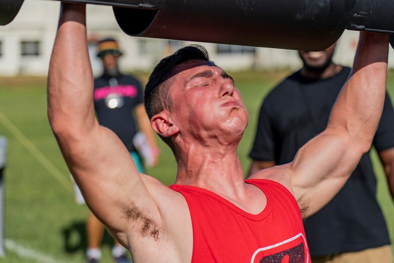 U.S. Marine Corps Cpl. Ezekiel Garza, a motor transportation mechanic with III Marine Expeditionary Force Support Battalion, executes a log clean and press during the Okinawa's Strongest: Battle of the South, Sept. 29, 2019 on Camp Foster, Okinawa, Japan. The competition challenges men and women to compete in physically demanding events to find the strongest on the island.