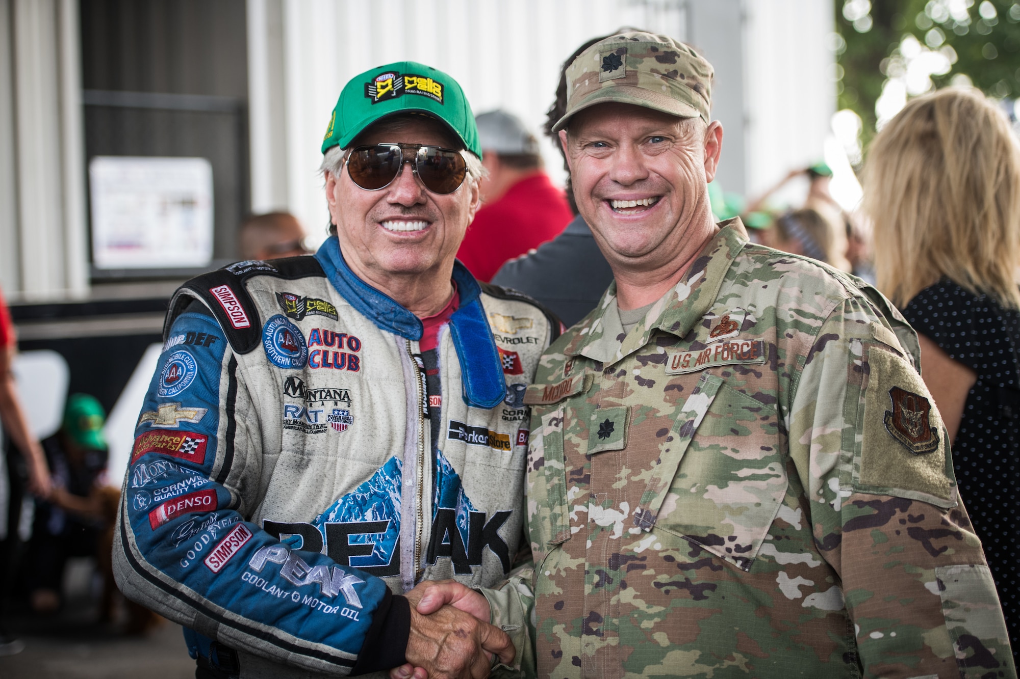 Lt. Col. William McLeod, 932nd Maintenance Group commander,  poses for a photo with a National Hot Rod Association race car driver just before the opening ceremony, Sept. 29, 2019, World Wide Technology Raceway at Gateway Motorsports Madison Illinois. McLeod was honored as a special guest for the day and presented a NHRA challenge coin. (U.S. Air Force photo by Master Sgt. Christopher Parr)