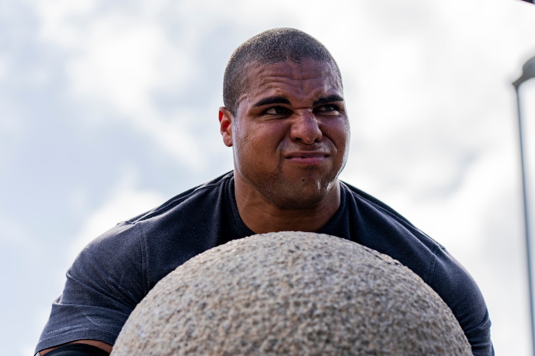 U.S. Marine Corps Cpl. Ian Dernbach, a heavy equipment operator with III Marine Expeditionary Force Support Battalion, lifts an atlas stone during the Okinawa's Strongest: Battle of the South, Sept. 29, 2019 on Camp Foster, Okinawa, Japan.