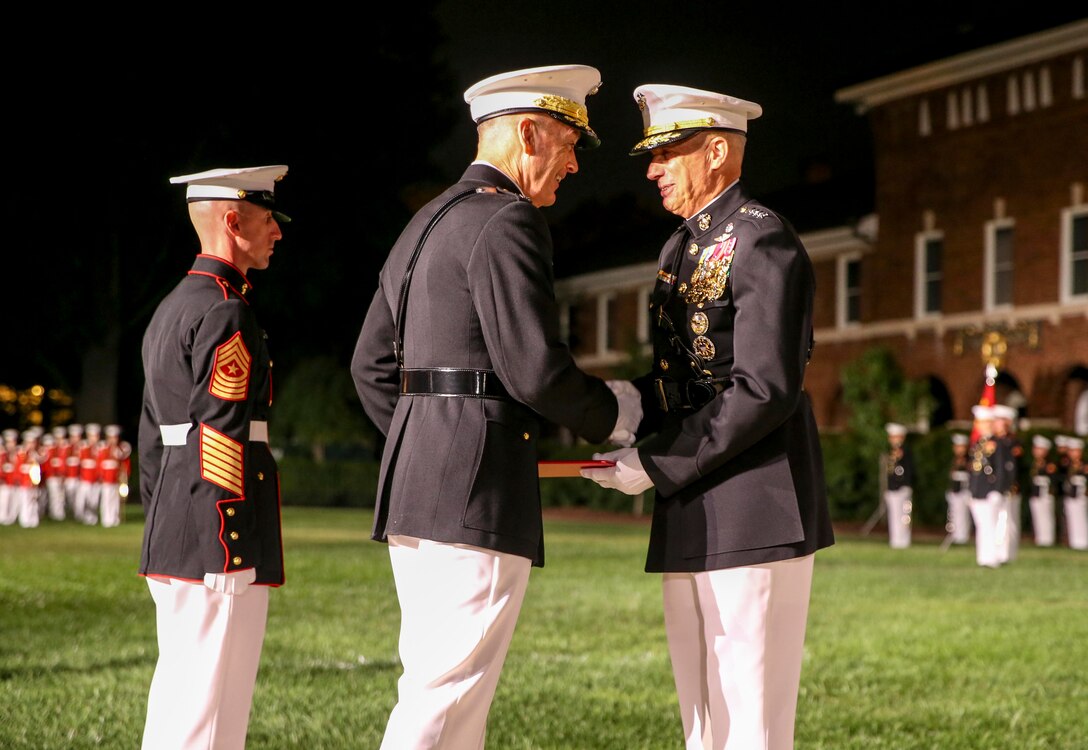 General Joseph F. Dunford, chairman of the Joint Chiefs of Staff, presents Gen. Thomas D. Waldhauser, commander, U.S. Africa Command, an award during a retirement ceremony for Waldhauser at Marine Barracks Washington, D.C., Sept 27, 2019. General Waldhauser served as an infantry officer at all levels in the Corps, including command of the 15th Marine Expeditionary Unit (Special Operations Capable) during combat operations in Afghanistan and Iraq. His General Officer commands included the Marine Corps Warfighting Laboratory, 1st Marine Division, I Marine Expeditionary Force, and Commander, Marine Corps Forces Central Command. He retired after more than 43 years of dedicated and faithful service to our Corps. (U.S. Marine Corps photo by Cpl. James Bourgeois)