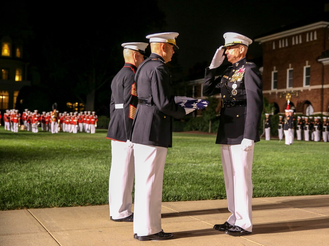 General David H. Berger, commandant of the Marine Corps, presents Gen. Thomas D. Waldhauser, commander, U.S. Africa Command, a folded flag during a retirement ceremony for Waldhauser at Marine Barracks Washington, D.C., Sept 27, 2019. General Waldhauser served as an infantry officer at all levels in the Corps, including command of the 15th Marine Expeditionary Unit (Special Operations Capable) during combat operations in Afghanistan and Iraq. His General Officer commands included the Marine Corps Warfighting Laboratory, 1st Marine Division, I Marine Expeditionary Force, and Commander, Marine Corps Forces Central Command. He retired after more than 43 years of dedicated and faithful service to our Corps. (U.S. Marine Corps photo by Cpl. James Bourgeois)