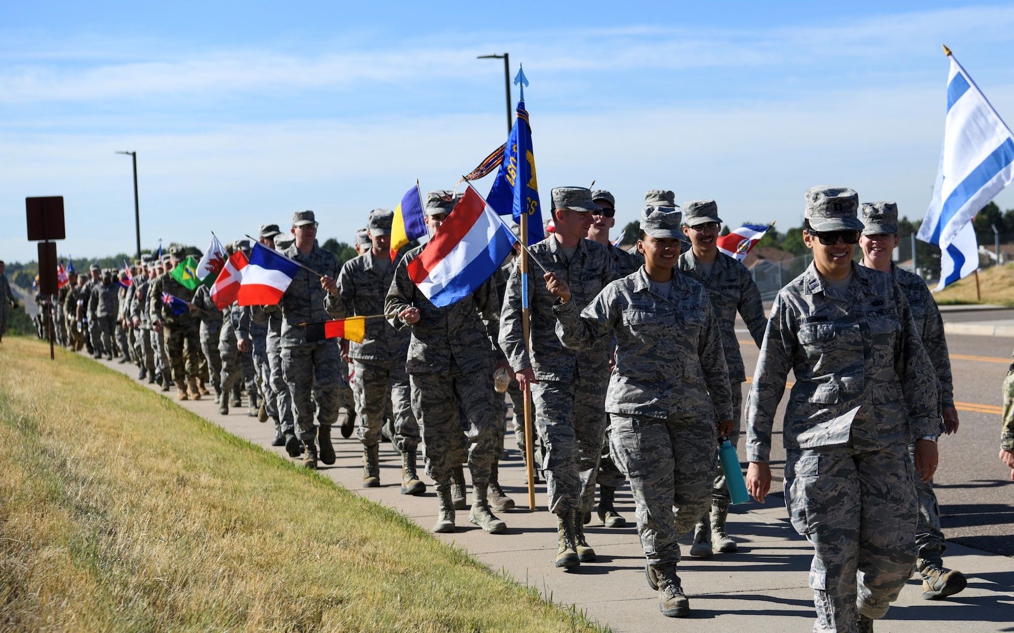 Members of Team Buckley took part in the Diversity Day march, Sept. 26, 2019, on Buckley Air Force Base, Colo. During the 1 mile march, participants held up flags from countries around the world. (U.S. Air Force photo by Senior Airman Michael D. Mathews)