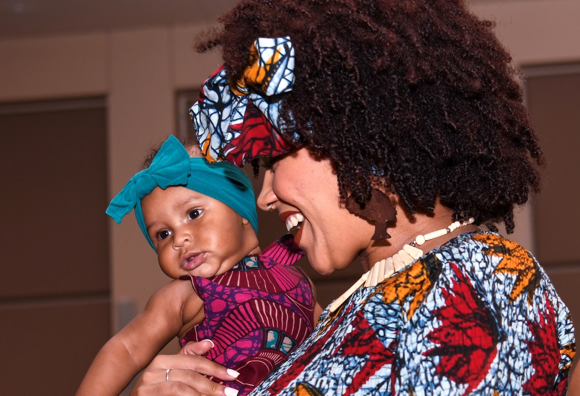 Marissa Stoudemire, Diversity Day volunteer, and her daughter Luna, dance on stage during the fashion show, Sept. 26, 2019, on Buckley Air Force Base, Colo. The Diversity Day fashion show let volunteers show unique styles and dances from their cultures. (U.S. Air Force photo by Senior Airman Michael D. Mathews)