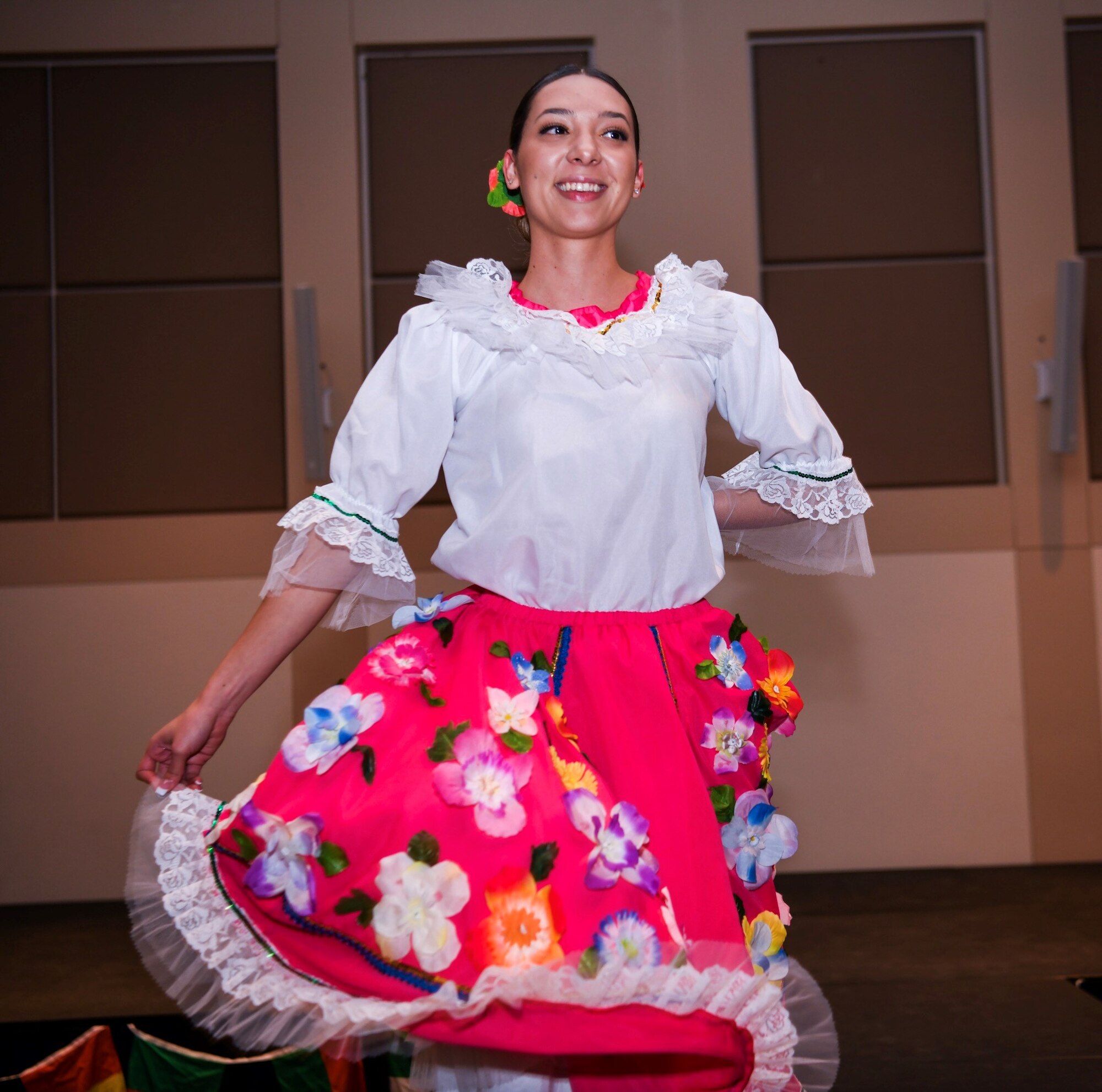 Tabares Manuella, Diversity Day volunteer, dances on stage during the fashion show, Sept. 26, 2019, on Buckley Air Force Base, Colo. The Diversity Day fashion show let volunteers show unique styles and dances from their cultures. (U.S. Air Force photo by Senior Airman Michael D. Mathews)