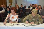 Brig. Gen. Laura Lenderman, commander, 502nd Air Base Wing and Joint Base San Antonio, and Diane Rath, Alamo Area Council of Governments executive director, signed a historical agreement at the AACOG Board of Directors meeting Sept. 25. This new blanket Intergovernmental Support Agreement, or IGSA, will afford JBSA the opportunity to bring requirements they would normally fill through traditional federal contracting actions to AACOG.