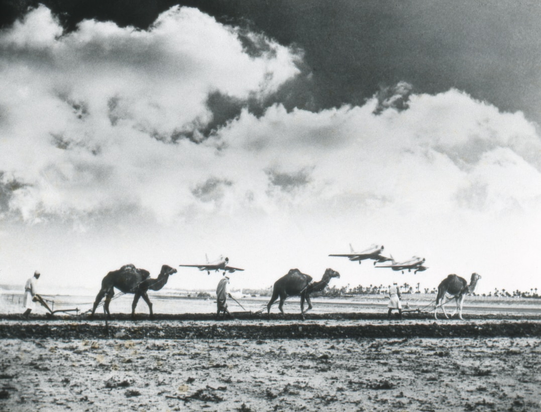 Progress versus the primitive: fighter planes fly over camels in Morocco.