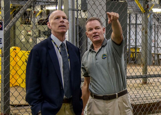 Naval Surface Warfare Center, Philadelphia Division (NSWCPD) engineer Andy Cairns and Naval Surface Warfare Center, Indian Head Explosive Ordinance Disposal Technology Division (NSWC IHEODTD Technical Director Ashley Johnson tour the DDG 51 Land Based Engineering Test Site on Sept. 16. NSWCPD’s Technical Director Thomas Perotti swapped places with NSWC IHEODTD’s Technical Director Ashley Johnson to learn more about each Command’s mission, leverage lessons learned, and identify new ways the two warfare centers could collaborate. (U.S. Navy photo by Keegan Rammel)