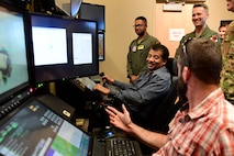 Members of the Defense Innovation Board (DIB) and Defense Digital Services (DDS) fly an MQ-9 Reaper flight simulator at Creech Air Force Base, Nevada, Sept. 12, 2019. The RPA enterprise is ever-changing, growing, and evolving to keep ahead of the nation’s adversaries. Without the bright minds and creative ideas of Airmen and DOD partners, the continued progression of the MQ-9 mission would not be possible. (U.S. Air Force photo by Senior Airman Haley Stevens)