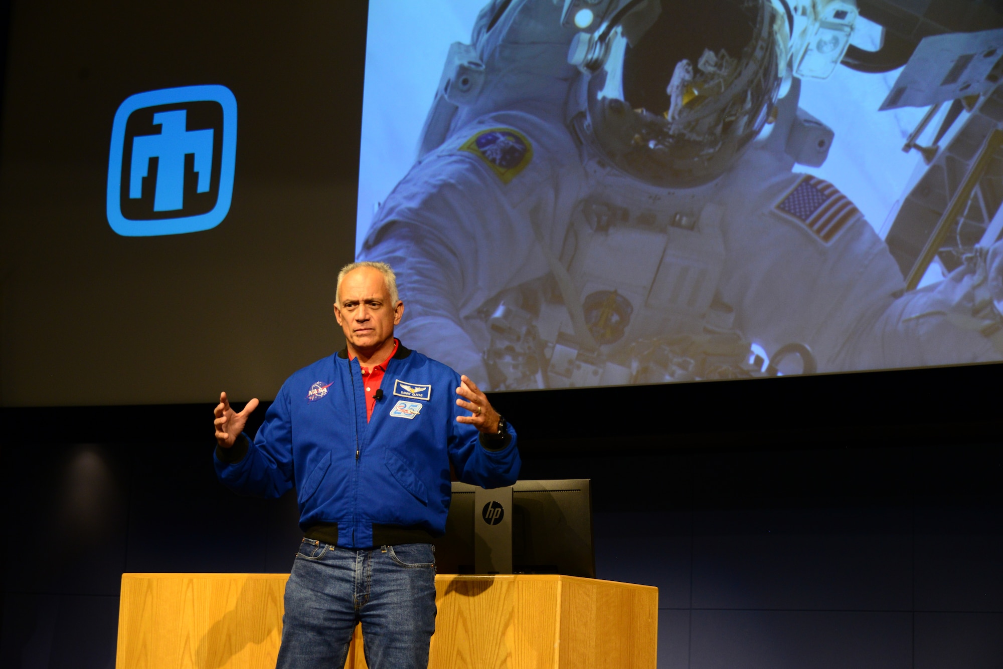 John Olivias, an American engineer and a former NASA astronaut, gives a presentation in the Steve Schiff Auditorium of Sandia National Laboratories on Sept. 25, 2019. Sandia hosted the event where participants sampled Hispanic foods, viewed and judged student artwork and listened to Olivias talk about his contributions, and journey with NASA. This was the first event to highlight Hispanic Heritage observance month on Kirtland. The month pays tribute to the contributions that Hispanics and Latino American culture have made to the fabric of our nation. (U.S. Air Force photo by Jessie Perkins)