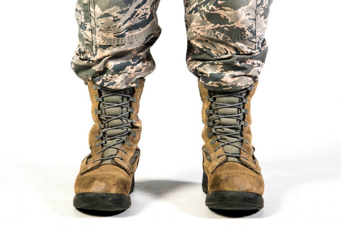 Studio shot of the feet and lower legs of an airman wearing combat boots.