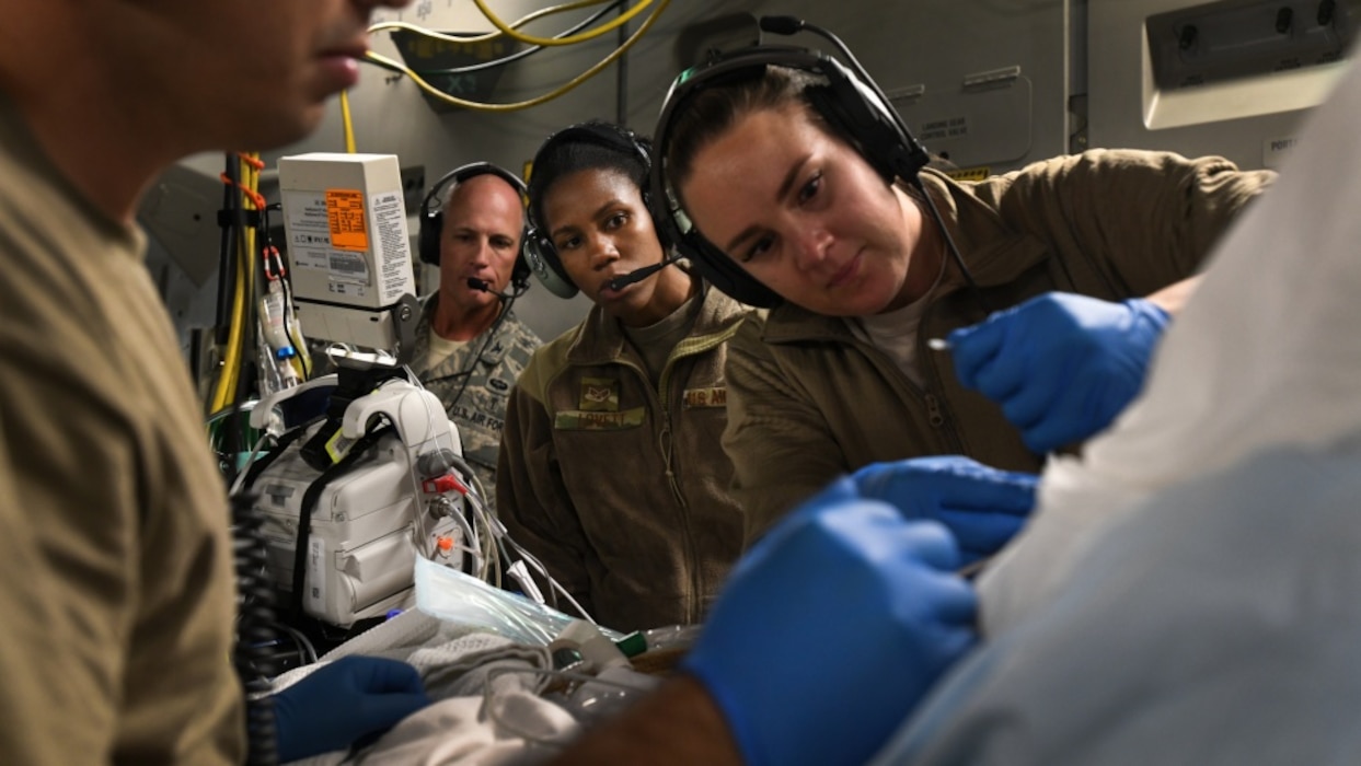 A critical care air transport team tends to a patient during a 20-hour direct flight from Bagram Airfield, Afghanistan, to San Antonio, Texas, Aug. 18, 2019. The service member was cared for by a joint service team of extracorporeal membrane oxygenation specialists, an aeromedical evacuation team, as well as a CCATT, in order to maintain the highest level of care possible during transport. (U.S. Air Force photo by Airman 1st Class Ryan Mancuso)