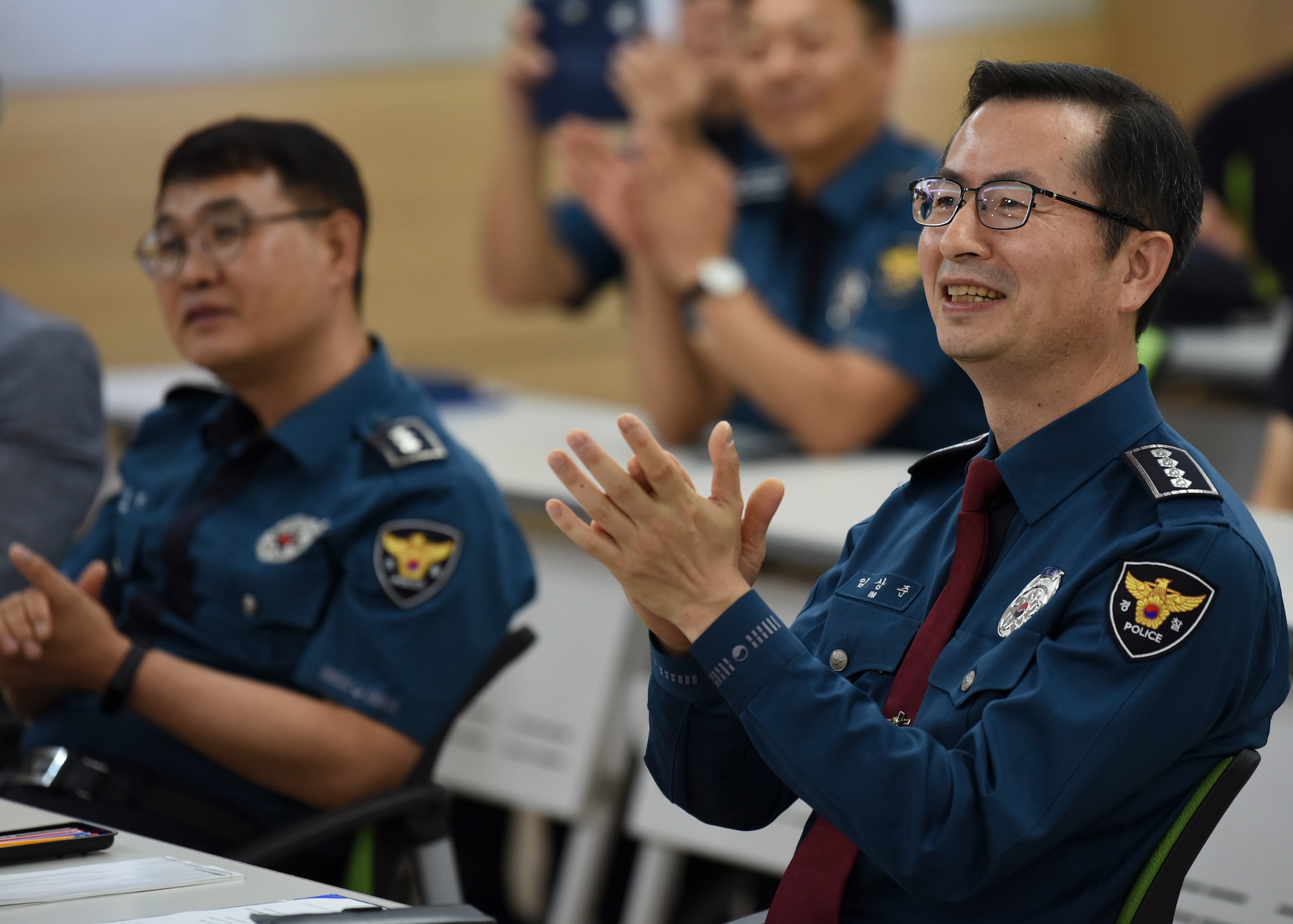 Sang-joon Lim, Gunsan Korean National Police chief, claps along to the U.S. Air Force Band of the Pacific in Gunsan City, Republic of Korea, Sept. 24, 2019. The band was established over 75 years ago but did not settle in its current location of Yokota Air Base, Japan until 1988. (U.S. Air Force photo by Staff Sgt. Anthony Hetlage)