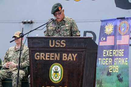 CELEBES SEA (Sept. 30, 2019) Malaysian Armed Forces (MAF) Lt. Gen. Dato’ Wira Zambrose bin Mohd Zain, Army Field Eastern Commander, addresses Malaysian and U.S. service members during an opening ceremony for exercise Tiger Strike 2019 aboard the amphibious transport dock ship USS Green Bay (LPD 20). Tiger Strike focuses on strengthening combined U.S. and Malaysian military interoperability and increasing combat readiness through amphibious operations and cultural exchanges between the MAF and the U.S. Navy, Marine Corps team.