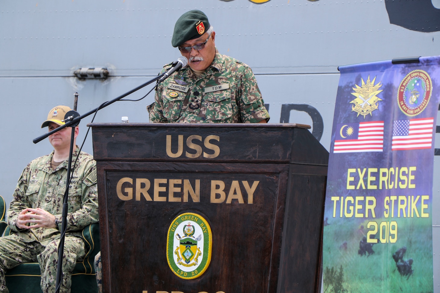 CELEBES SEA (Sept. 30, 2019) Malaysian Armed Forces (MAF) Lt. Gen. Dato’ Wira Zambrose bin Mohd Zain, Army Field Eastern Commander, addresses Malaysian and U.S. service members during an opening ceremony for exercise Tiger Strike 2019 aboard the amphibious transport dock ship USS Green Bay (LPD 20). Tiger Strike focuses on strengthening combined U.S. and Malaysian military interoperability and increasing combat readiness through amphibious operations and cultural exchanges between the MAF and the U.S. Navy, Marine Corps team.