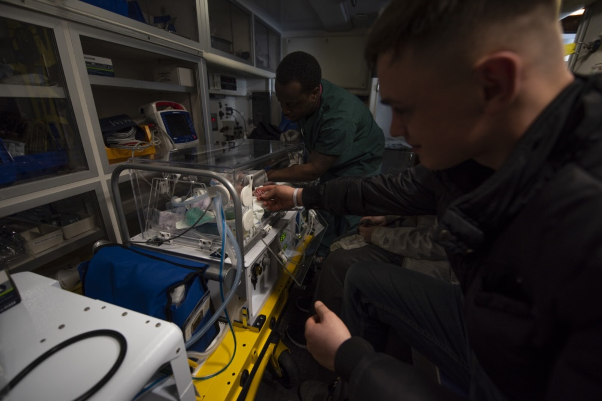 U.S. Army Specialist Cody McFall from U.S. Army Camp Walker, Republic of Korea, 188th Military Police Company, comforts one of his newborn twins while he sleeps, before an aeromedical evacuation mission, March 30, 2020, at Osan Air Base, Republic of Korea.