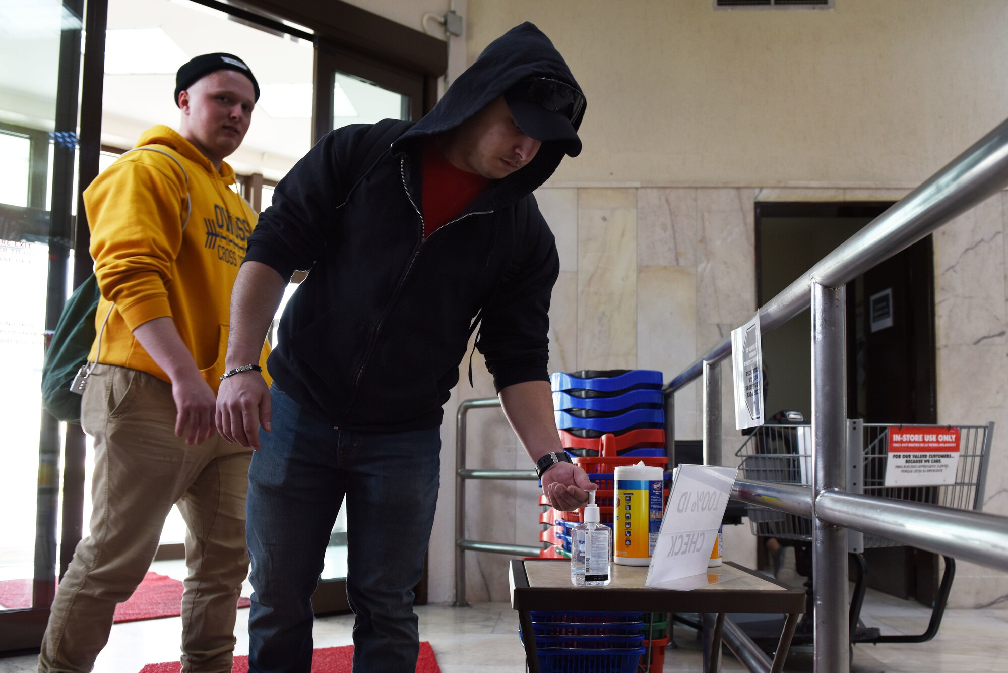 Customers sanitize their hands upon entering the Commissary March 20, 2020, at Incirlik Air Base Turkey. Units and facilities around the installation have enhanced their sanitation procedures in order to combat the possible spread of the Coronavirus. (U.S. Air Force photo by Staff Sgt. Joshua Magbanua)