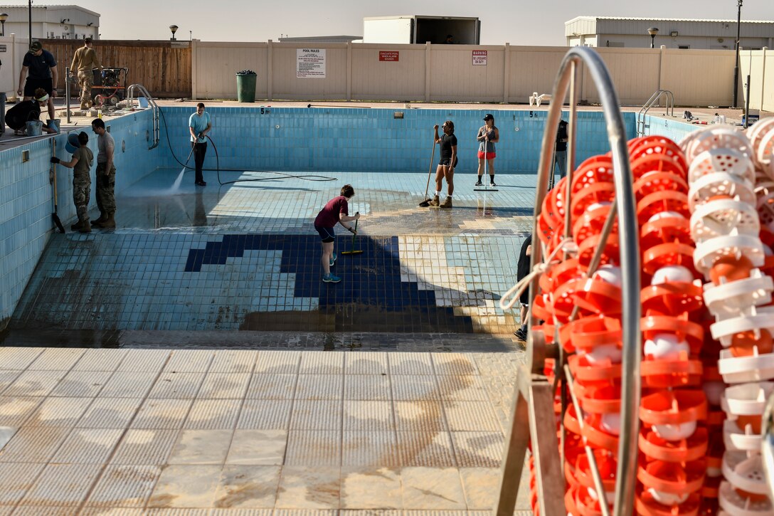 Airmen cleaning pools