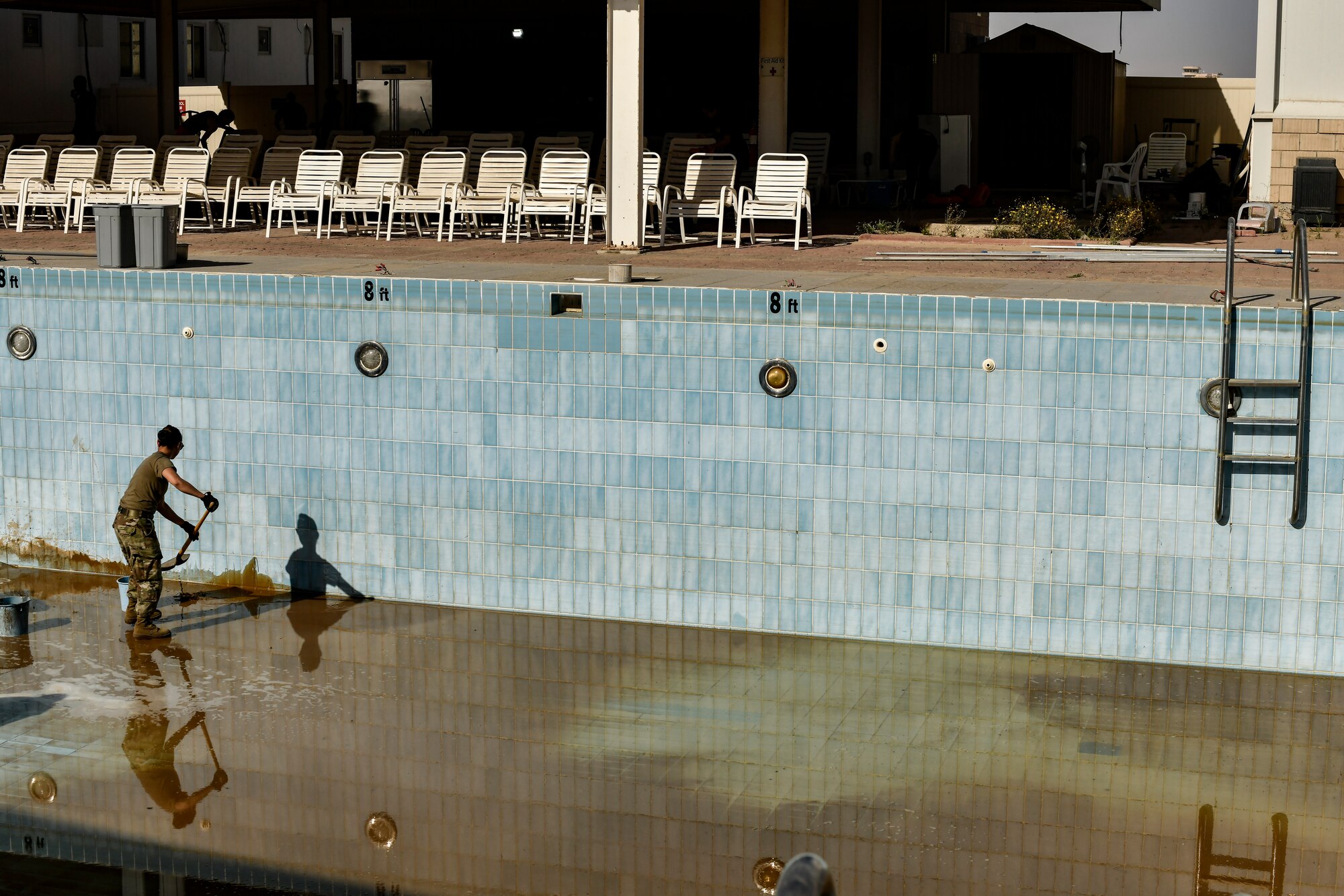 Airmen cleaning pools