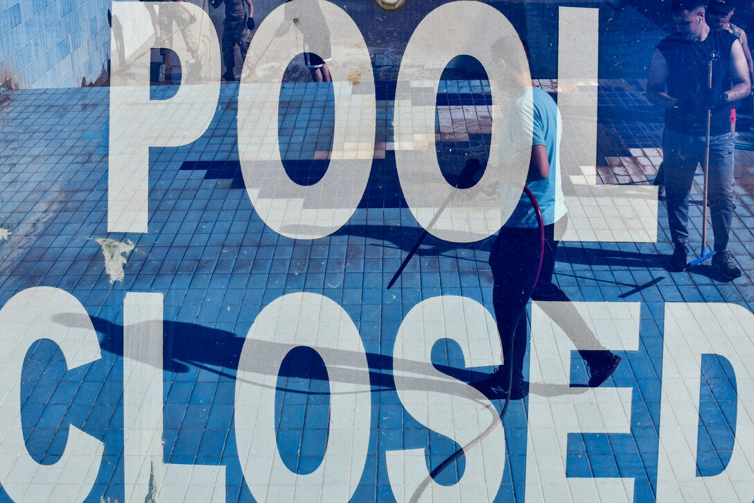 Airmen cleaning pools